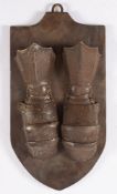 A pair of iron mitten gauntlets mounted