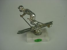 A nickel plated skier mascot on later ma