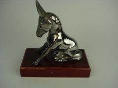 A 1930's seated donkey mascot:, on later