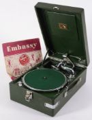 An HMV wind-up gramophone in dark green