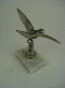 An aluminium dove mascot:, with outstret