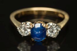 A sapphire and diamond three-stone ring: