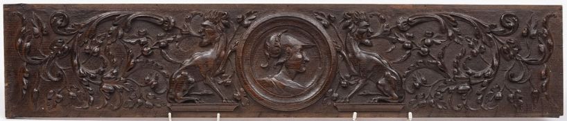 An antique carved oak panel: the central