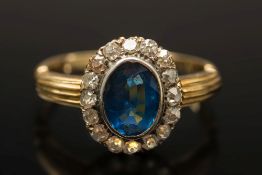 A gold, sapphire and diamond oval cluste
