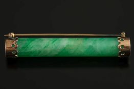 A cylindrical green jade rod mounted bar