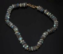A faceted labradorite bead and gold colo