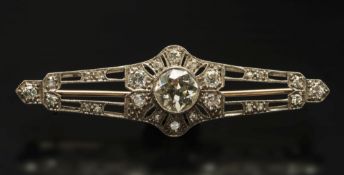 A diamond mounted bar brooch: with centr