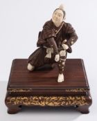 A Japanese ivory and hardwood okimono: o