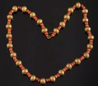 An antique gold and coral  bead single-s