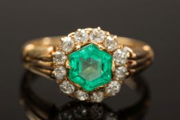 A gold, emerald and diamond circular clu