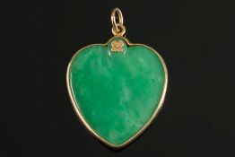 A heart shaped green jade pendant:, the