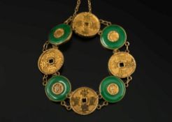 A Chinese gold and green jade disc panel