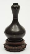 A Chinese bronze flask: of squat baluste