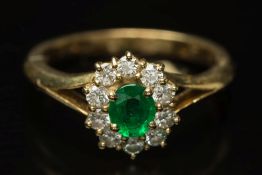 A modern 18ct gold, emerald and diamond