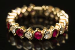 A modern, ruby and diamond eternity ring