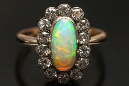 An opal and diamond oval cluster ring:,