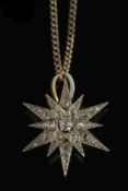 A diamond mounted twelve-pointed star br