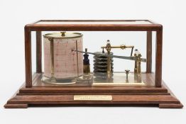 An early 20th century oak cased barograph:, 8 day drum movement, seven diaphragm atmospheres,