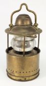 A circular brass ship's lamp:,