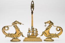 A brass doorstop with a circular portrait of Admiral Nelson over a model of HMS Victory,