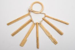 A 19th century set of seven sailorwork marine ivory model tools:, mainly rasps and a flensing knife,