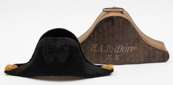 A Royal Navy bicorn hat in a Russian lacquer box inscribed H A Judkins RN:,