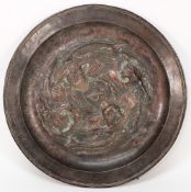 A Newlyn style copper dish:, with central repousse decoration of two fish circling a worm, unsigned,