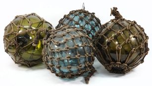 Four large glass floats:, of typical form with ropework..