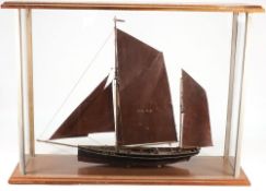 A cased model of a fishing boat PH42:, fully rigged with over painted metal sails,