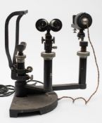 An optometrist's slit lamp by Hamblin, London:, with black crackle finish. .