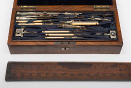 A late 19th/early 20th century walnut cased geometry set, together with a brass mounted rule:,