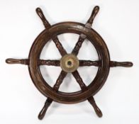 A teak and brass helm, unsigned:, 77cm diameter.