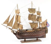 A wood block model of HMS Victory: partially rigged with lifeboats and  brass cannon,