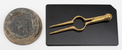 A pair of 16th century brass dividers, together with a circular lead weight initialled 'CR':,