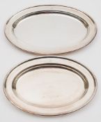 Two silver plated serving dishes with shipping line engraved logos:, (emblems worn), 31cm and 36cm.