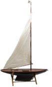 A late 19th/ early 20th century pond yacht:, fully rigged over deck fittings,