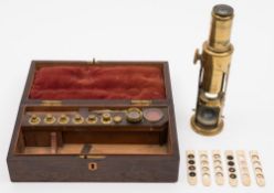 A 19th century brass student microscope in rosewood case with lenses and objectives: unsigned,