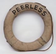 An early 20th century grey canvas and rope life preserver 'Peerless':, 70cm diameter.
