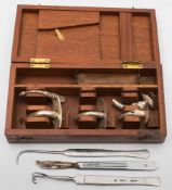 A mahogany cased tracheotomy kit:, in a fitted case (incomplete).