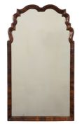 An 18th Century walnut mirror:, of cartouche outline, the plate within a moulded surround,