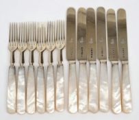 A set of twelve Victorian silver gilt and mother of pearl fruit knives and forks,