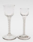Two opaque twist wine glasses: one with ogee shaped bowl with wrythen basal flutes on a straight