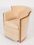 An Art Deco walnut veneer framed and upholstered armchair:, of tub shaped outline,