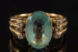 An aquamarine and diamond ring:, the central, oval aquamarine approximately 14mm long x 10mm wide,