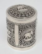 A late 19th century Indian silver canister and cover: the rectangular panels decorated with animals,