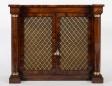 A Regency rosewood dwarf side cabinet:, of recessed breakfront outline,