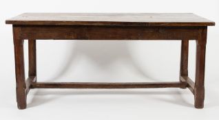 An 18th/19th Century French oak farmhouse table:, with a rectangular plank top on chamfered legs,