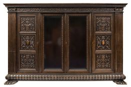 A  late 19th/early 20th Century Century German carved walnut bookcase:,