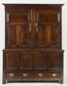 An 18th Century oak side cupboard:, the upper part now fitted with a brass hanging rail,