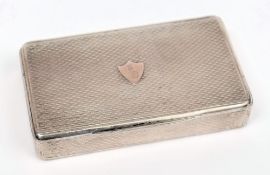 A 19th Century continental silver snuff box: crested to a gold shield on the hinged lid with engine
